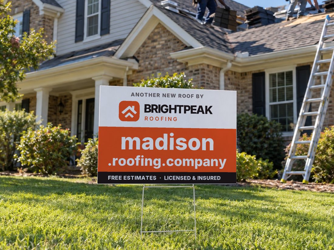 madison.roofing.company on a yard sign in front of a house getting a new roof